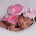 Bébé nouveau-né endormi dans un décor de papillons, séance naissance réalisée par Carolina Photographies à Fréjus
